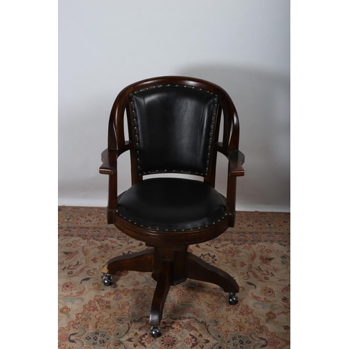 94 - A MAHOGANY SWIVEL LIBRARY CHAIR the curved top rail above an upholstered panel and seat with moulded... 