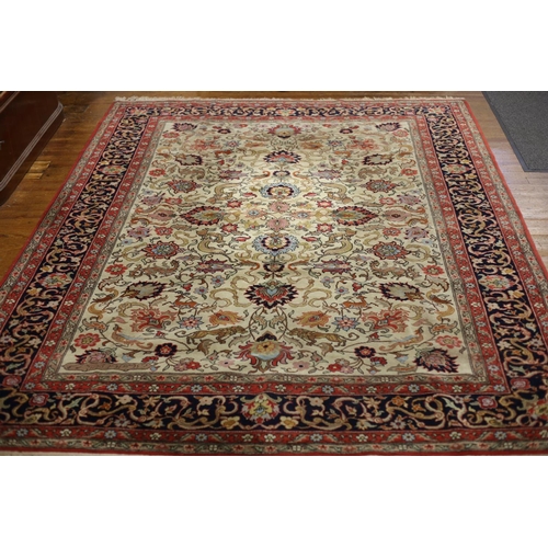 413 - AN ORIENTAL WOOL RUG the beige light red and indigo ground with central panel filled with flowerhead... 