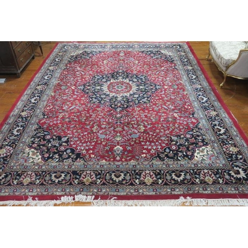 416 - A TABRIZ WOOL RUG the wine and indigo ground with central floral panel within a conforming border 41... 