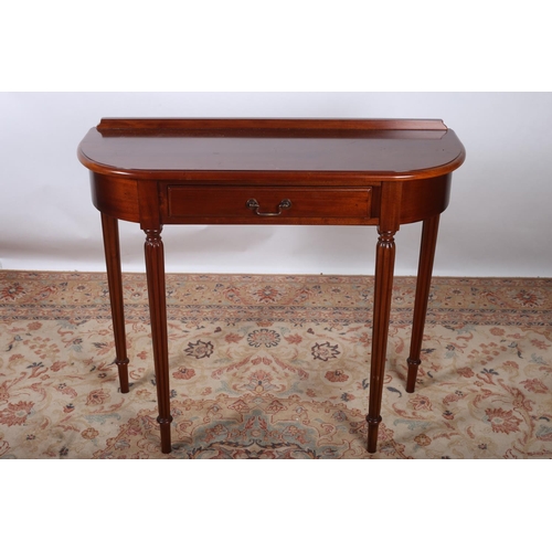 418 - A REGENCY DESIGN MAHOGANY SIDE TABLE of rectangular bowed outline the shaped top above a frieze draw... 