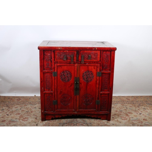 61 - AN ORIENTAL HARDWOOD CABINET with two frieze drawers and pierced and carved panel doors flanked by c... 
