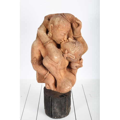 86 - A TERRACOTTA FIGURE embracing couple raised on a rustic base
51cm (h)