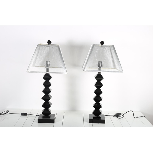 87 - A PAIR OF BLACK GLASS TABLE LAMPS each with a knopped column on platform supports with white wire tr... 