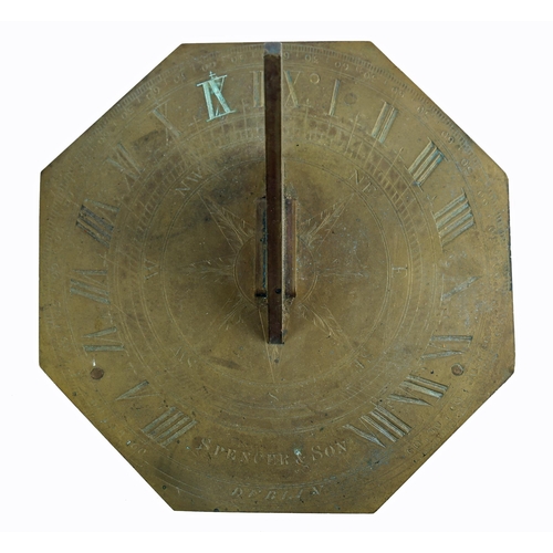 24 - An early 19th century brass octagonal sundial, the gnomon centred on a finely engraved compass rose ... 