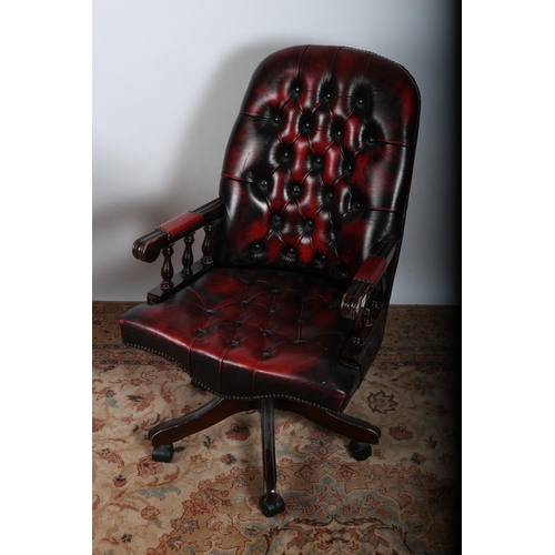 1 - A STAINED WOOD AND HIDE UPHOLSTERED SWIVEL LIBRARY CHAIR with deep buttoned upholstered back and sea... 