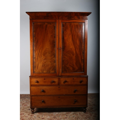 15 - A GEORGIAN MAHOGANY AND ROSEWOOD CROSSBANDED LINEN PRESS the moulded cornice above a pair of panel d... 