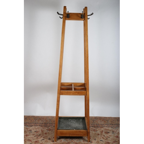157 - A VINTAGE OAK HAT COAT AND STICK STAND of rectangular spreading form with removable drip pan on moul... 