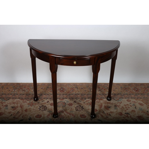 27 - A QUEEN ANNE DESIGN MAHOGANY SIDE TABLE of demi lune outline the shaped top with frieze drawer on ca... 