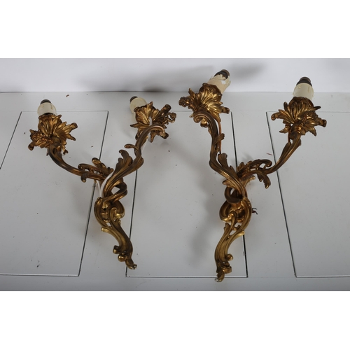 384 - A PAIR OF 19TH CENTURY CONTINENTAL GILT BRASS ROCOCO STYLE TWO BRANCH GAS WALL LIGHTS now converted ... 