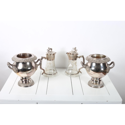 386 - A PAIR OF SILVER PLATED CHAMPAGNE ICE BUCKETS each of bulbous tapering form moulded in relief with f... 