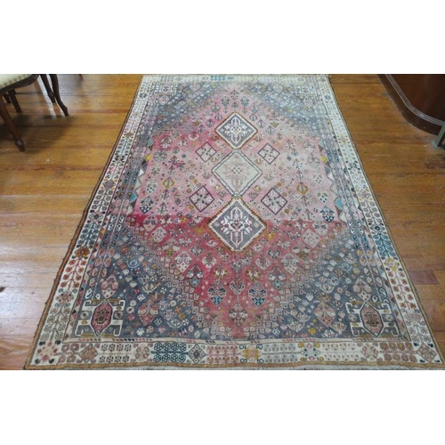 AN ORIENTAL WOOL RUG the light pink and light blue ground with central