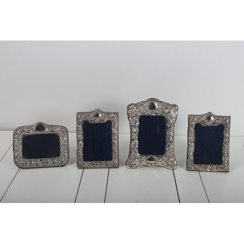 487 - FOUR SILVER EMBOSSED PHOTO FRAMES