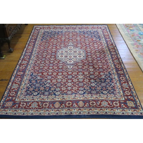 56 - A TABRIZ WOOL RUG the wine and indigo ground with central floral panel within a conforming border
24... 