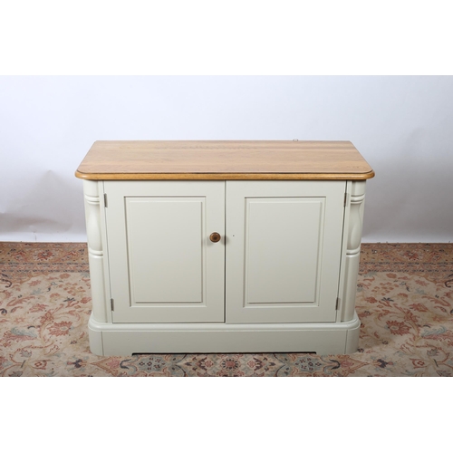 608 - AN OAK AND PAINTED SIDE CABINET of rectangular outline with panel doors flanked by half pilaster sup... 