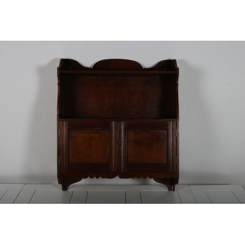 615 - A VINTAGE MAHOGANY HANGING WALL CABINET the superstructure with open shelves above a pair of cupboar... 