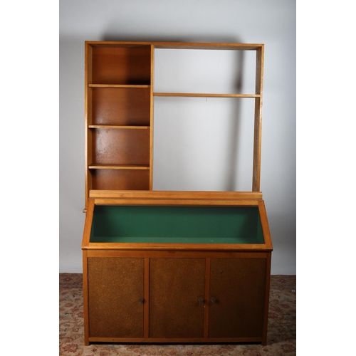 622 - A VINTAGE SATIN BIRCH SLOPE FRONT DISPLAY CABINET with glazed hinged panel above three cupboards on ... 