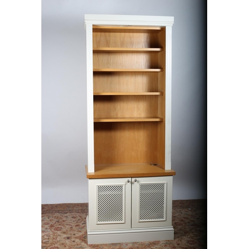 92 - AN OAK AND CREAM PAINTED OPEN FRONT BOOKCASE the moulded cornice above five shelves four adjustable ... 