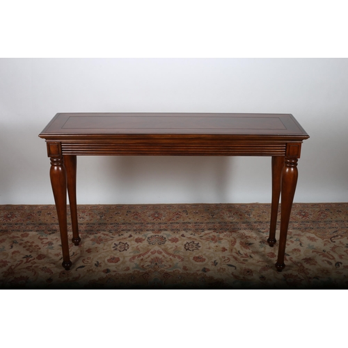 26 - A KINGWOOD AND MAHOGANY CONSOLE TABLE of rectangular outline with reeded apron on cylindrical taperi... 