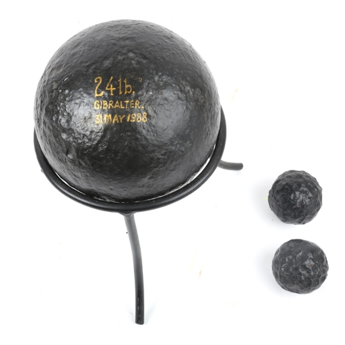 361 - Cannon balls. Three various cannon balls, a 24lb cannon ball on stand, and two 1lb cannon balls. (3)