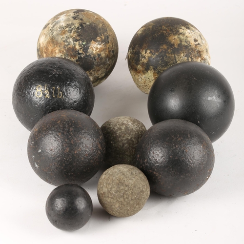 363 - A collection of nine various cannon balls.