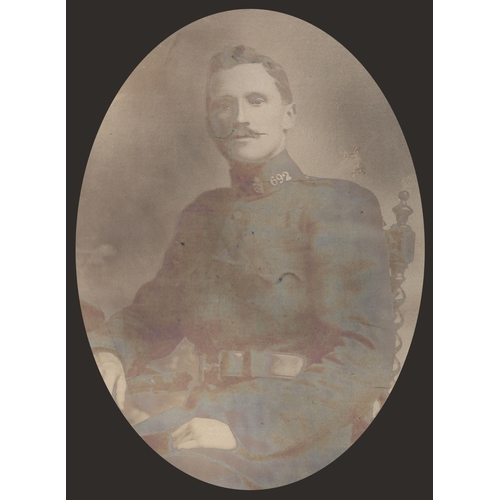 59 - Royal Irish Constabulary, photographic studio portrait of a constable seated in uniform, by Pidduck ... 