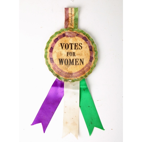 65 - Votes for Women rosette. A satin rosette in suffrage colours of purple, white and green centred by '... 