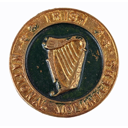 80 - Irish National Volunteers. A die-stamped, gilt-metal buttonhole badge, a relief harp in a green fiel... 