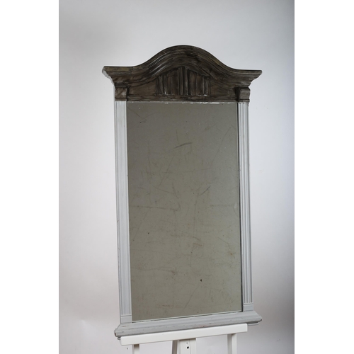 83 - A CONTINENTAL OAK PAINTED MIRROR the rectangular plate within a reeded frame with linen fold and arc... 