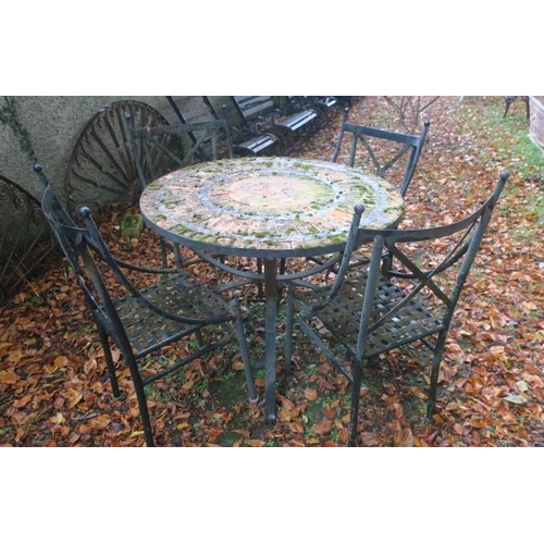 812 - A FIVE PIECE WROUGHT IRON PATIO SUITE comprising a set of four chairs each with a curved top rail wi... 