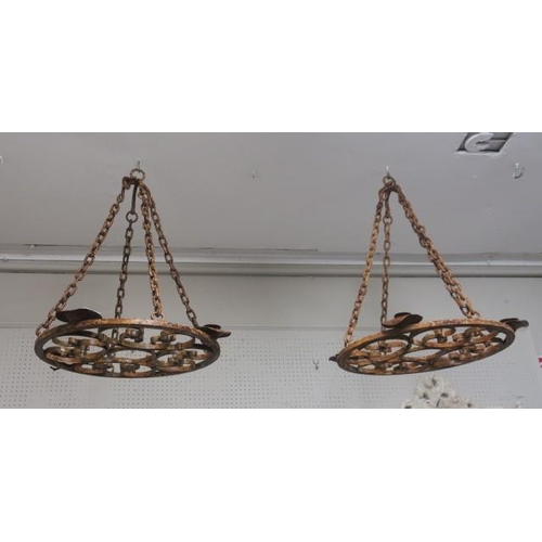 832 - A PAIR OF WROUGHT IRON HANGING CENTRAL LIGHTS of circular outline with C-scroll decoration and candl... 