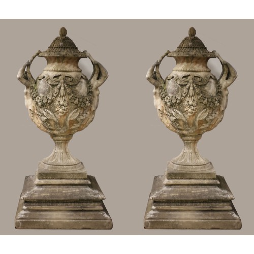 78 - A VERY FINE AND IMPRESSIVE PAIR OF SANDSTONE URNS each of ovoid tapering form hung with ribbon tied ... 