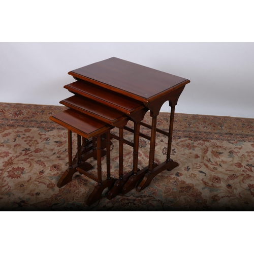 833 - A NEST OF QUARTETTO MAHOGANY TABLES each of rectangular outline raised on dual turned supports and p... 