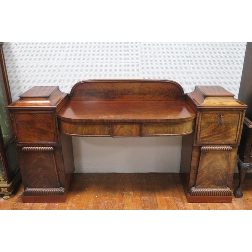 7 - A GOOD REGENCY MAHOGANY PEDESTAL SIDEBOARD of rectangular bowed outline the arched gallery above a b... 