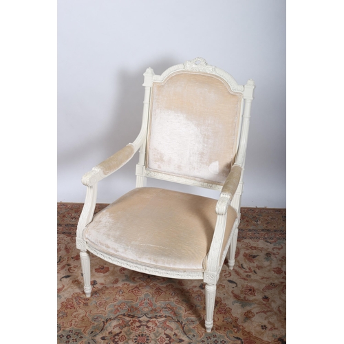 760 - A CONTINENTAL WHITE PAINTED AND UPHOLSTERED ARMCHAIR the pierced flowerhead cresting above an uphols... 