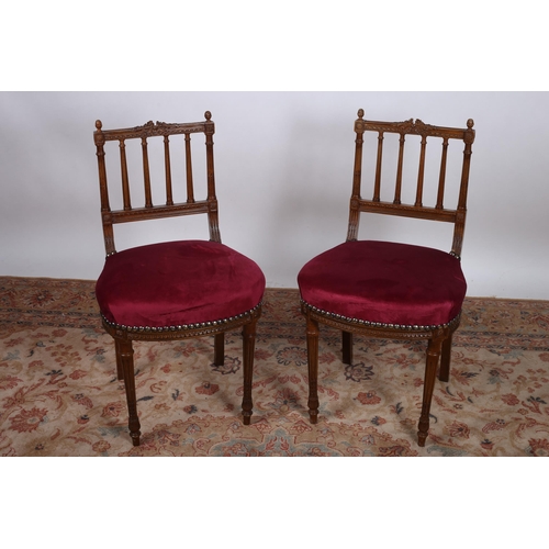 774 - A PAIR OF 19TH CENTURY CONTINENTAL MAHOGANY SIDE CHAIRS each with a foliate ribbon tied carved top r... 