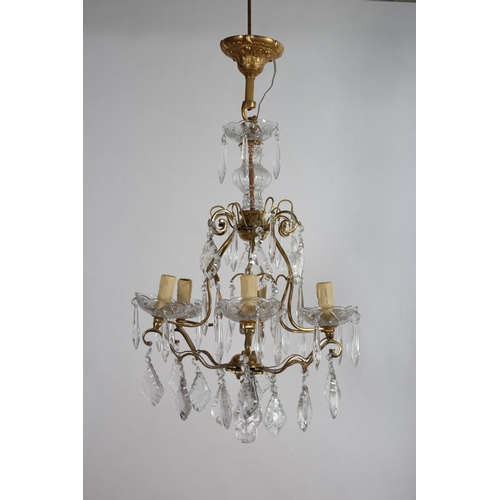 826 - A CONTINENTAL GILT BRASS AND CUT GLASS SIX BRANCH CHANDELIER hung with pendant drops 
64cm drop x 43... 