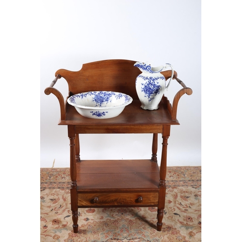 12 - A 19TH CENTURY MAHOGANY WASHSTAND the shaped back above two shelves with frieze drawer on turned leg... 