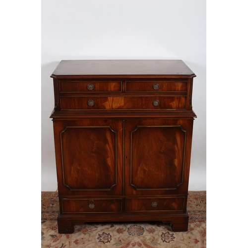16 - A MAHOGANY SIDE CABINET of rectangular outline the hinged lid above three false drawers with cupboar... 