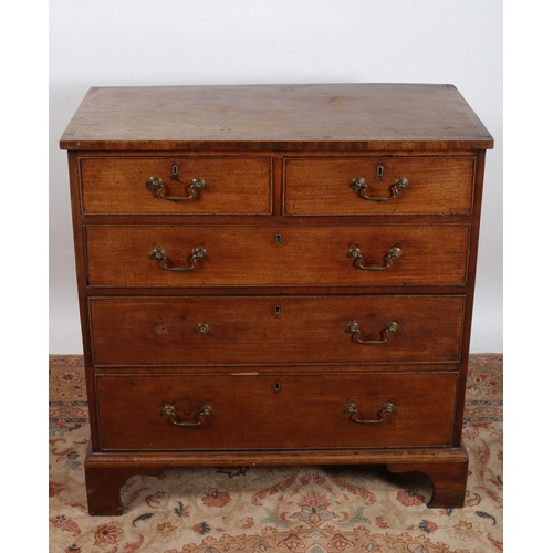 26 - A GEORGIAN MAHOGANY CROSSBANDED CHEST of rectangular outline the shaped top above two short and thre... 