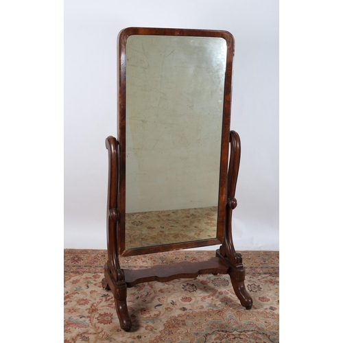 29 - A 19TH CENTURY MAHOGANY CHEVAL MIRROR the rectangular plate within a moulded frame raised on scroll ... 