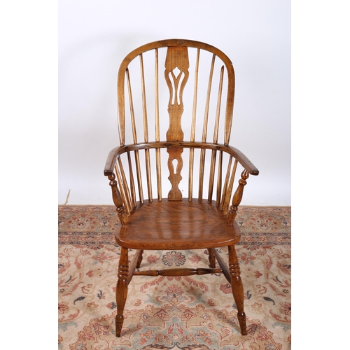 3 - AN ELM WOOD WINDSOR CHAIR the arched top rail above a pierced splat with shaped seat on baluster leg... 