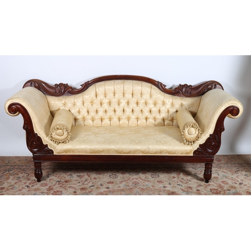 30 - A VICTORIAN DESIGN CARVED MAHOGANY AND UPHOLSTERED SETTEE the serpentine carved top rail above a but... 