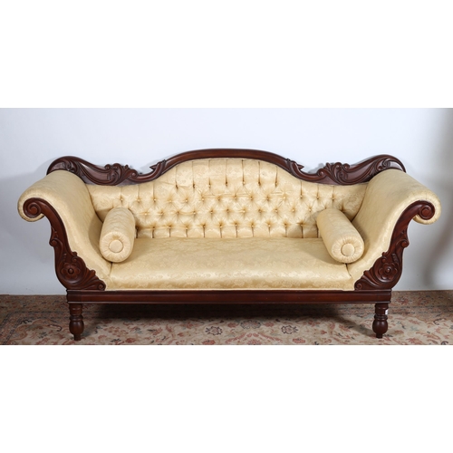 31 - A VICTORIAN DESIGN CARVED MAHOGANY AND UPHOLSTERED SETTEE the serpentine carved top rail above a but... 