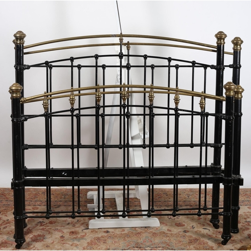 40 - A BRASS AND CAST IRON BED the arched top rail with cylindrical splats and conforming posts with bras... 