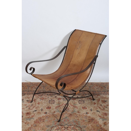 41 - A VINTAGE WROUGHT IRON AND HIDE UPHOLSTERED LOUNGE CHAIR the hide upholstered panelled back and seat... 