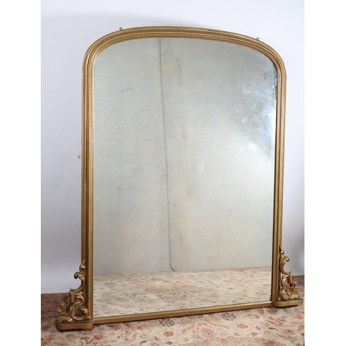 46 - A 19TH CENTURY GILTWOOD AND GESSO OVERMANTLE MIRROR the rectangular arched plate within a moulded fr... 