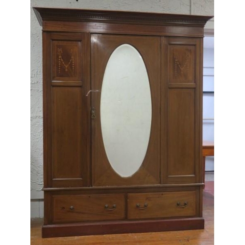 5 - AN EDWARDIAN MAHOGANY AND SATINWOOD INLAID TWO DOOR WARDROBE the dentil moulded cornice above an ova... 