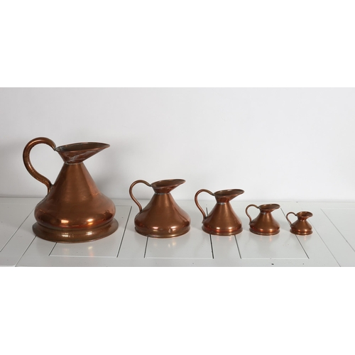 514 - A SET OF FIVE GRADUATED COPPER MEASURES