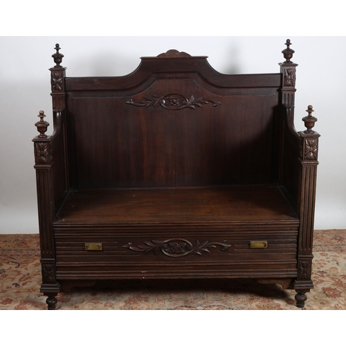 52 - A LATE 19TH CENTURY CARVED OAK SEAT the rectangular arched back with foliate carved decoration above... 