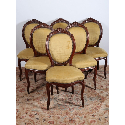 65 - A SET OF SIX CONTINENTAL CARVED MAHOGANY AND UPHOLSTERED DINING CHAIRS each with an oval upholstered... 